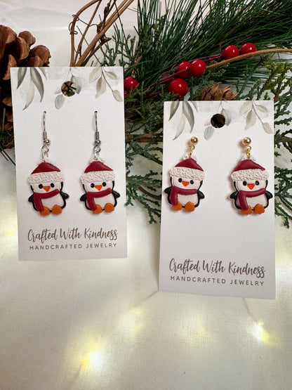 Detailed Christmas penguin earrings. Each penguin has a red winter hat and red scarf on. All made from polymer clay. 