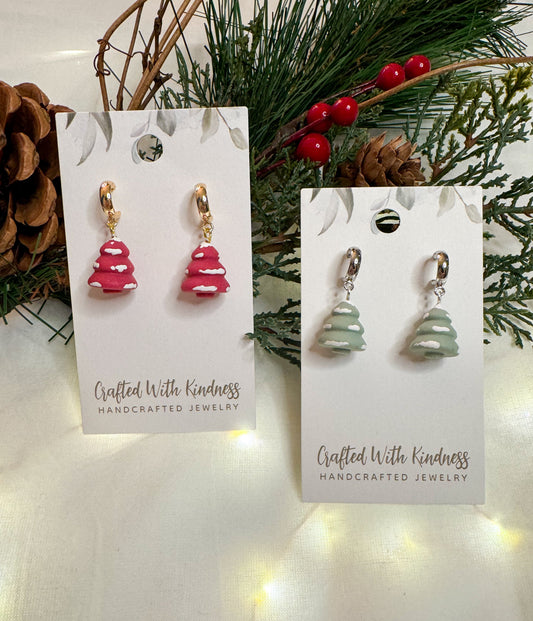 Christmas tree huggie earrings in a hot pink and light green color with a light dusting of snow. 