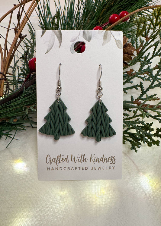 Dark green Christmas tree earrings that are hand braided to look like they are knitted. 