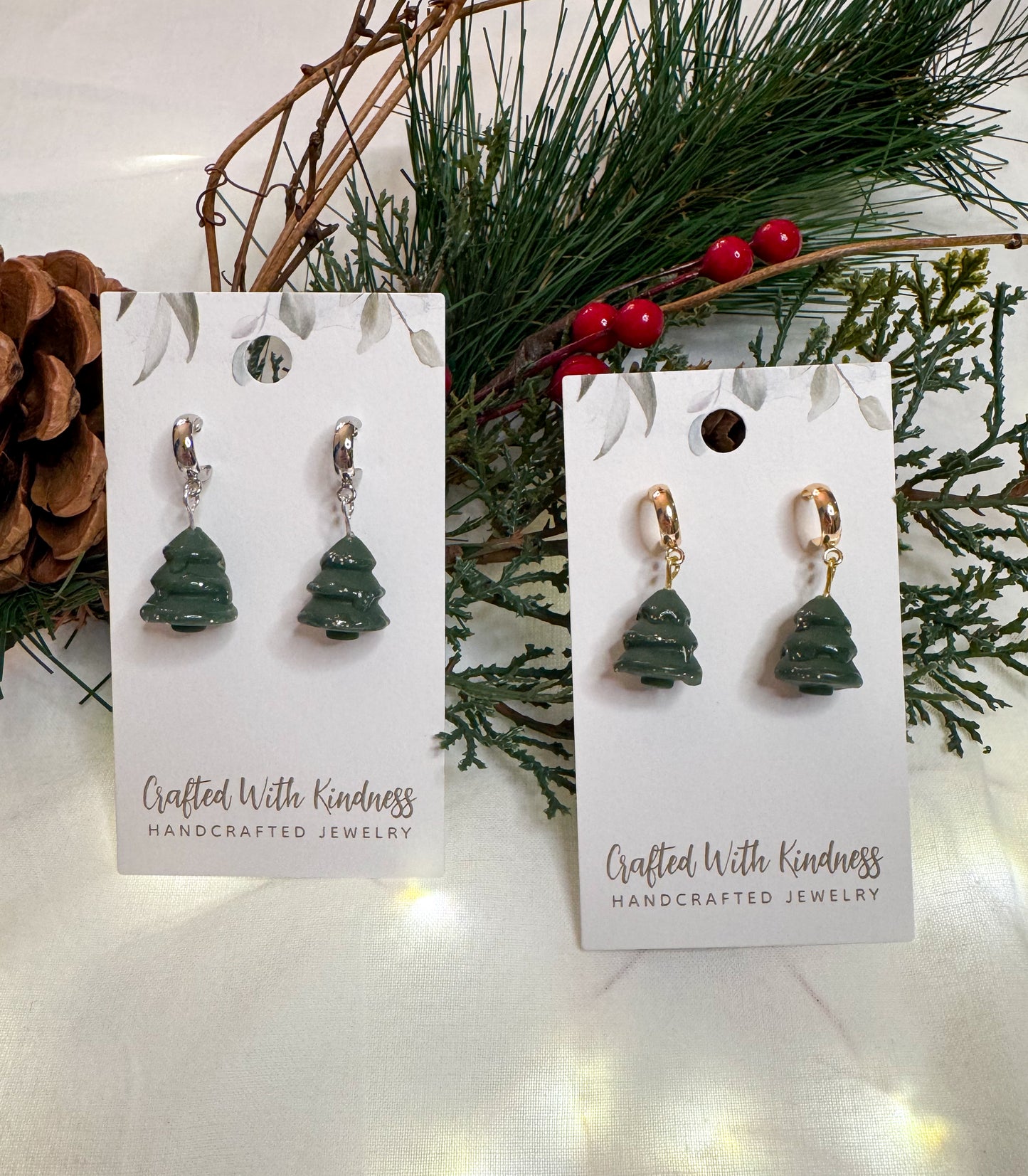 Gold and silver version of Christmas tree huggie earrings with a resin and glitter drizzle.